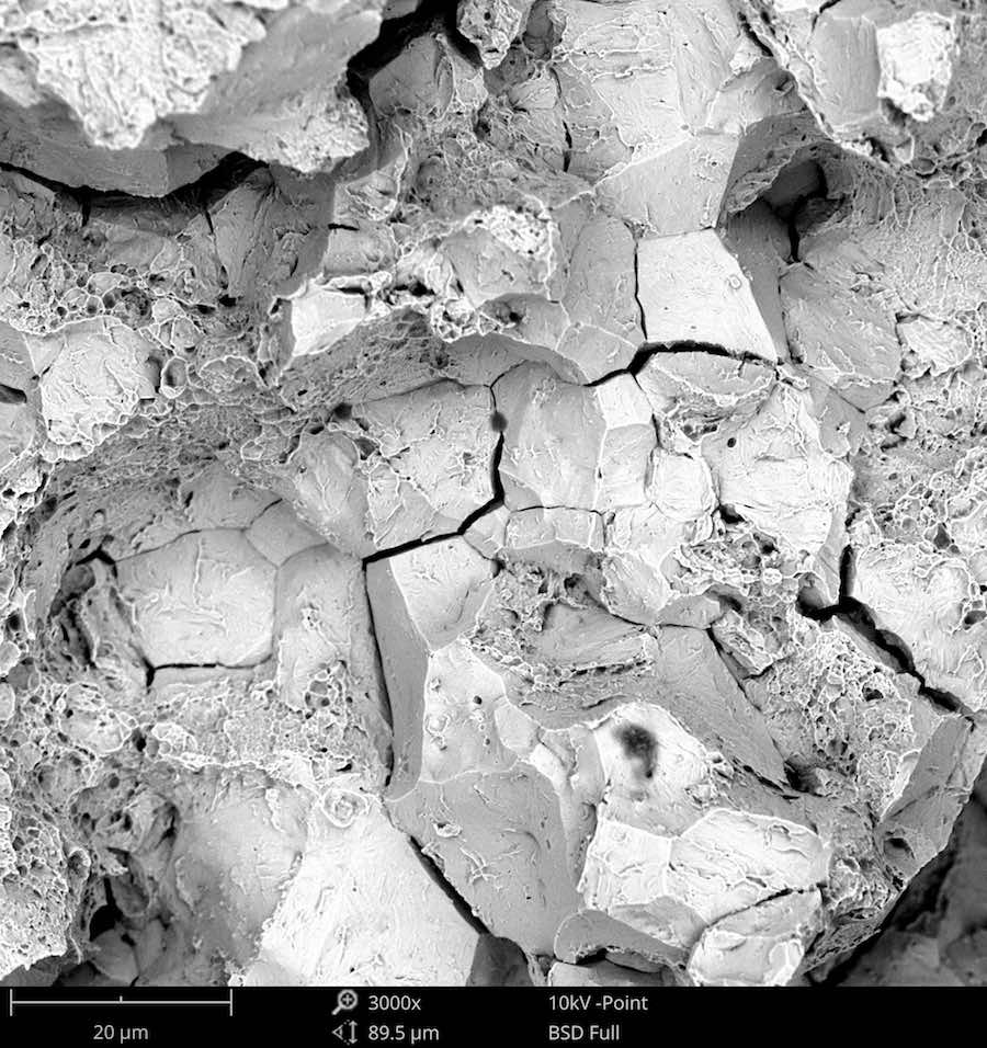 Scanning Electron Microscope image of Intergranular Cleavage in a Steel Bolt at 3000x magnification