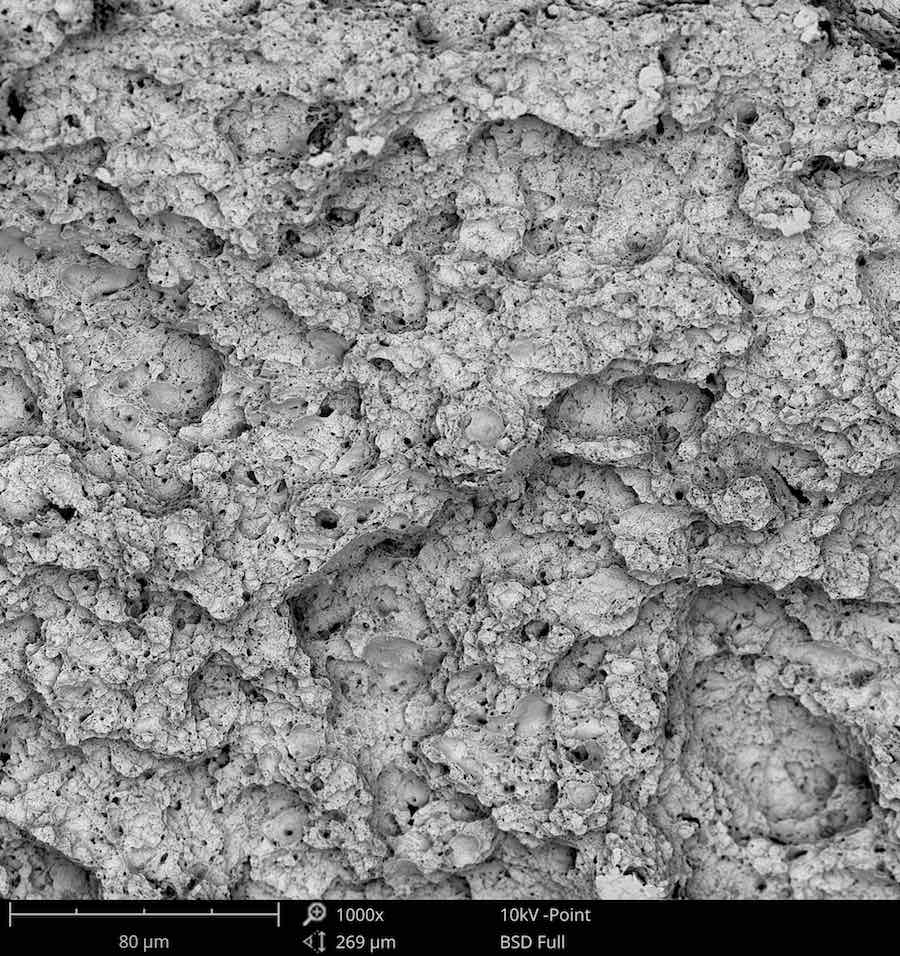 Scanning Electron Microscope Image of Equiaxed Microvoid Coalescence at 1000x magnification
